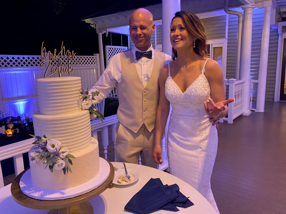 A three-tier white wedding cake