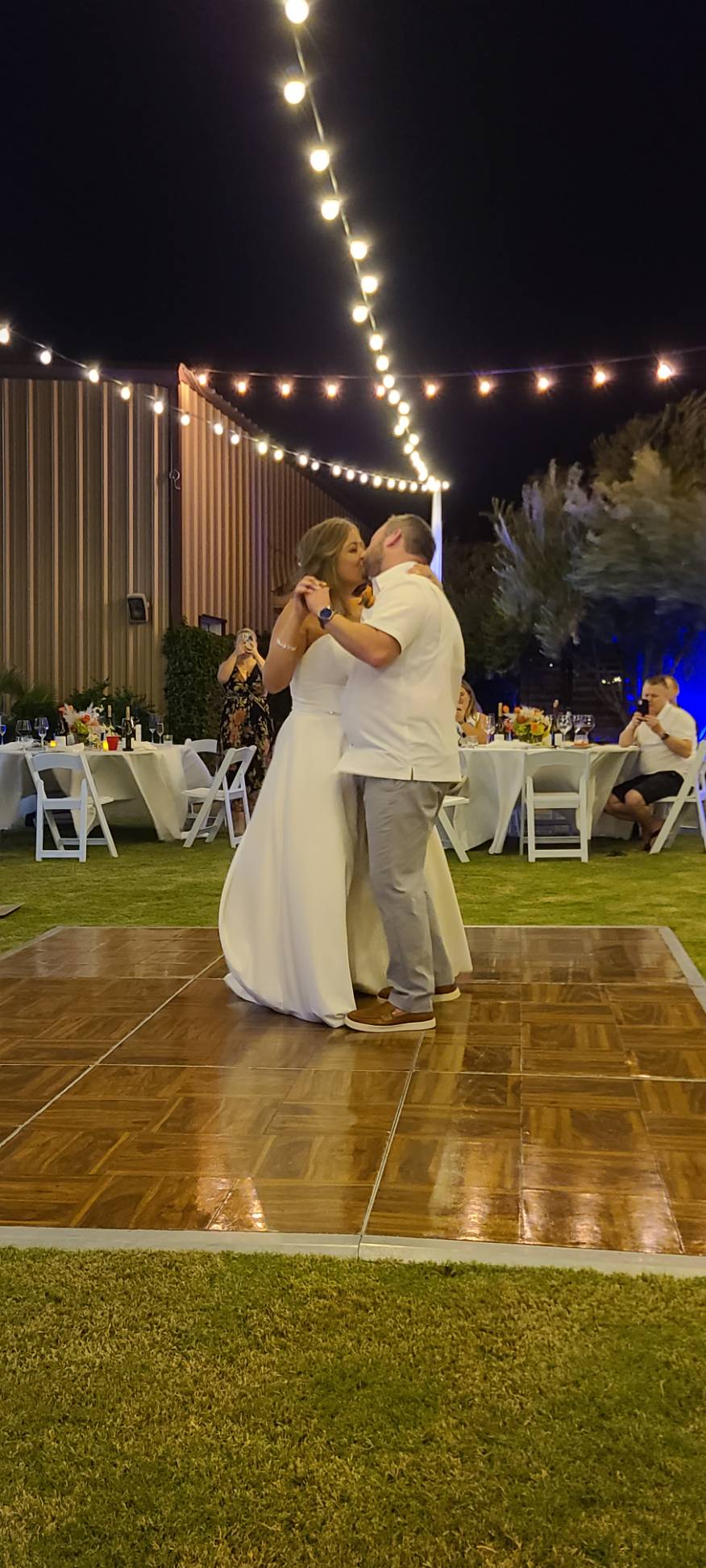 Wedding couple on dance floor on grassy lawn